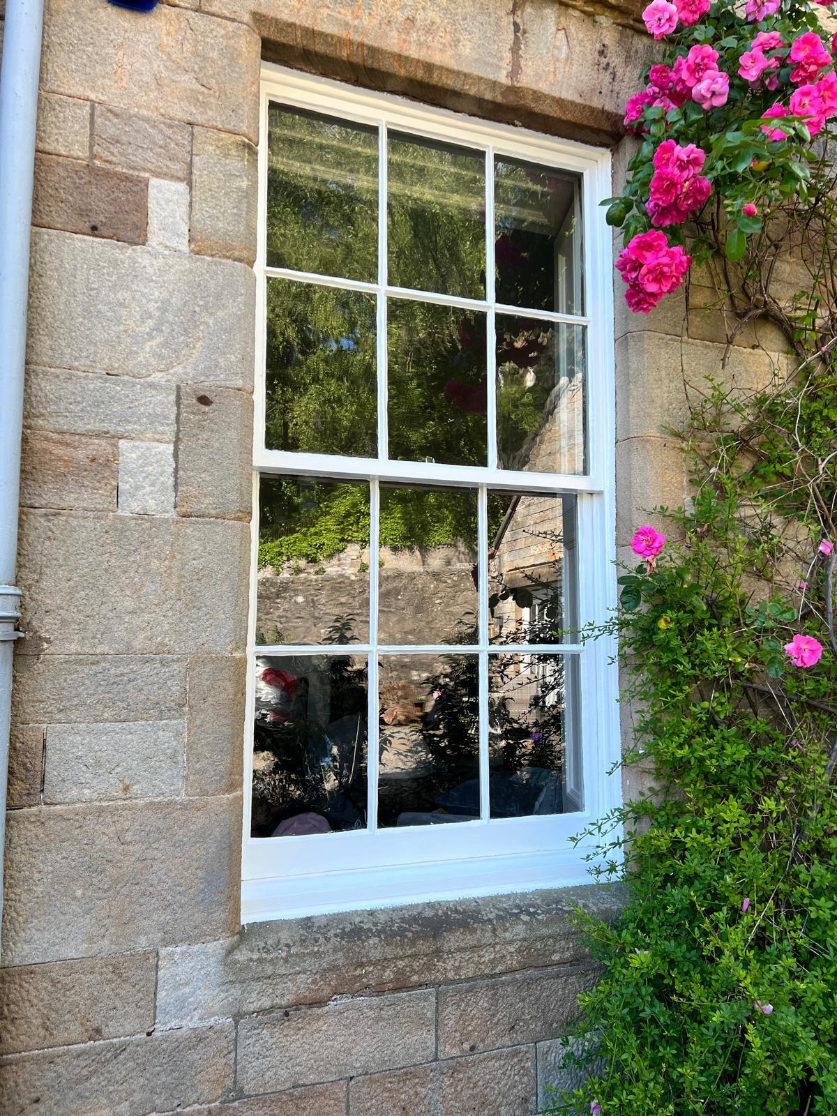 Restored traditional timber sash and case window in a stone property in Bridge of Allan
